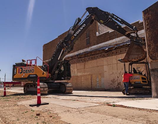 Demotion experts with Intercon began unloading equipment on Wednesday in preparation for the deconstruction of White's Hardware and Family Dollar stores that were damaged beyond repair by last summer's supercell. PHOTO BY JEFF HURT