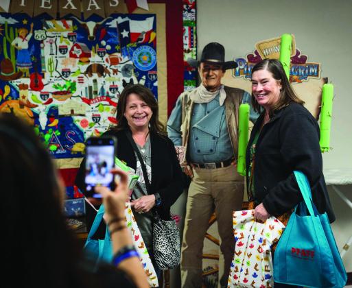 Shop Hoppers pose with The Duke as the Quilting Barn in Aspermont welcomes quilting enthusiasts.