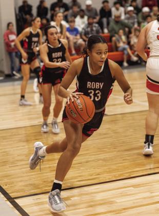during the Lady Lions' 50-27 district win over the Rotan Lady Hammers Tuesday night.. PHOTO BY MARK MARTINEZ Roby junior Joselynn Williams transitions from a rebound