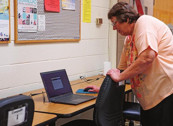 Stonewall County Librarian Kathy Boyles, shows off one of the new laptop computers that the library was able to purchase through the Texas Supports Libraries Grant during the Open House Monday morning.