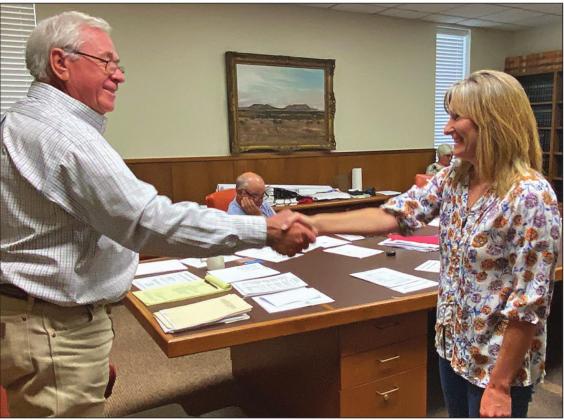 Stonewall County Judge Ronnie Moorhead shakes the hand of Darla Pearson after swearing her in as the new Stonewall Justice of the Peace.