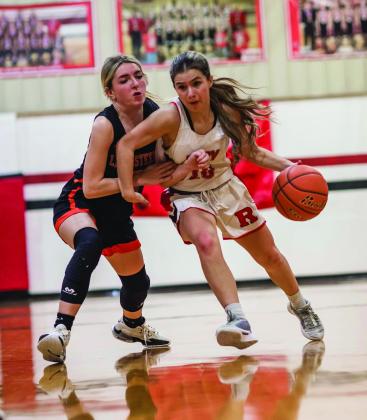 Roby Junior Lilly Benson battles with a Lady Steer defender during the Lady Lion's close 27-- 34 loss to Robert Lee Tuesday night. The Lady Lions will begin this district play this Friday at home against Lueders-Avoca. PHOTO BY MARK MARTINEZ